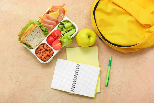 Backpack Stationery Lunch Box Tasty Food Grunge Orange Background — Stock Photo, Image