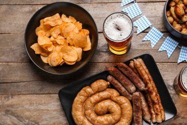 Bir bardak soğuk bira ve ahşap arka planda farklı atıştırmalıklar. Ekim Festivali Kutlaması