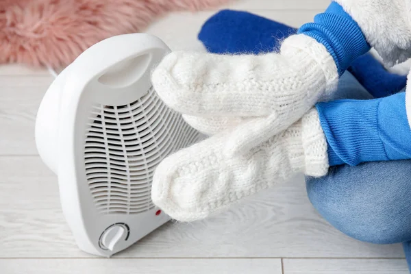 Woman Warming Hands Mittens Electric Fan Heater Home Closeup — Stock Photo, Image
