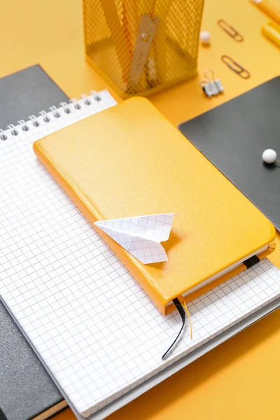 Notizbücher Papierflieger Und Verschiedene Schulsachen Auf Orangefarbenem Hintergrund Nahaufnahme — Stockfoto