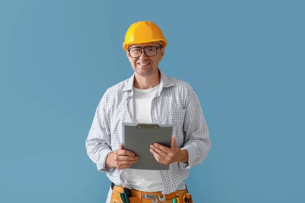 Mature Builder Clipboard Blue Background — Stock Photo, Image