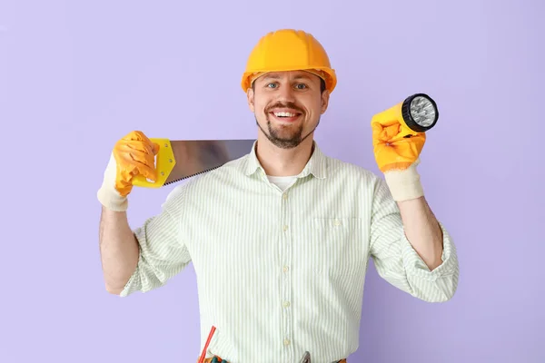 Male Builder Handsaw Flashlight Lilac Background — Stock Photo, Image