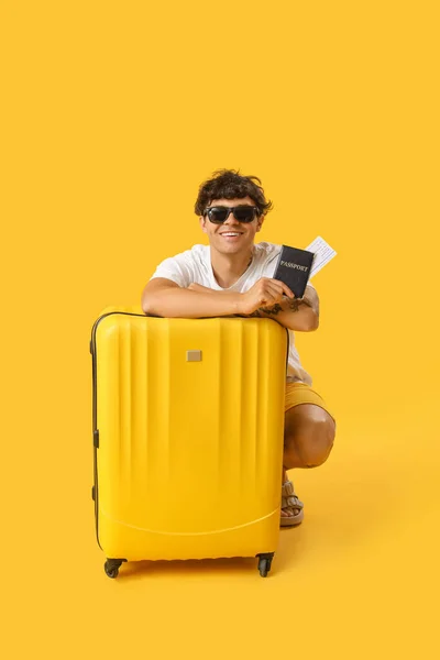 Junger Mann Mit Sonnenbrille Pass Und Koffer Auf Gelbem Hintergrund — Stockfoto