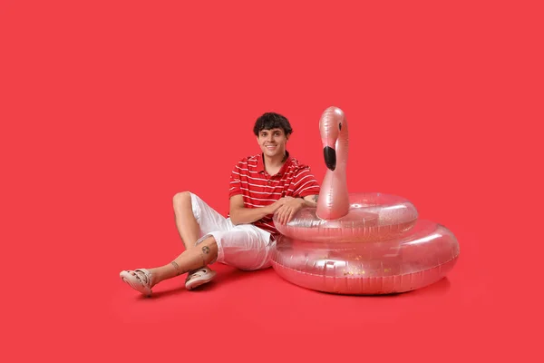 Young Man Swim Rings Sitting Red Background — Stock Photo, Image