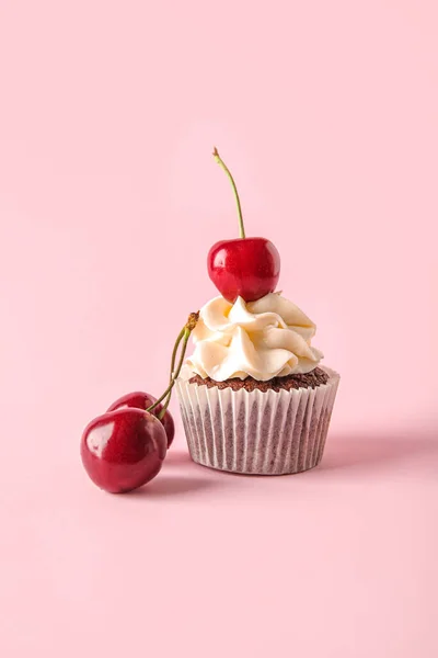 stock image Tasty cherry cupcake on pink background