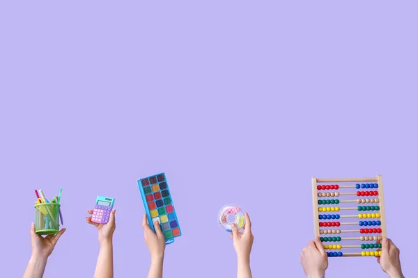 Many Hands Holding School Supplies Lilac Background — Stock Photo, Image