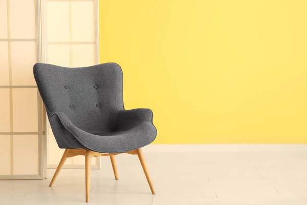 Stylish Black Armchair Folding Screen Yellow Wall — Stock Photo, Image