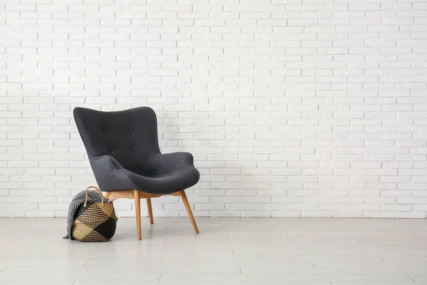 Stylish Black Armchair Wicker Bag Blanket White Brick Wall — Stock Photo, Image