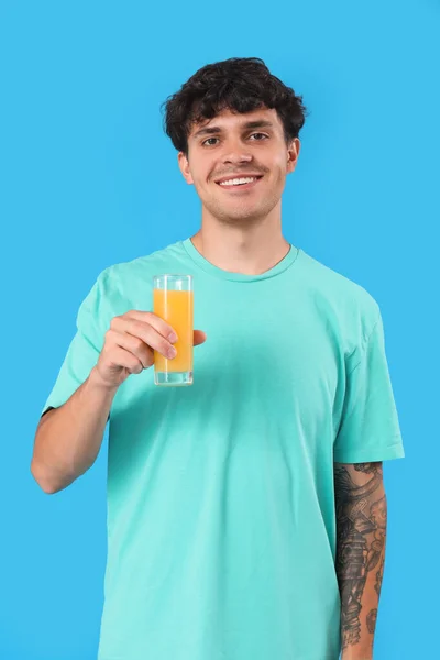Young Man Glass Orange Juice Blue Background — Stock Photo, Image