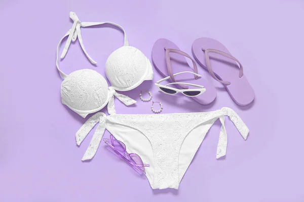 Stylish Swimsuit Flip Flops Sunglasses Earrings Lilac Background — Stock Photo, Image