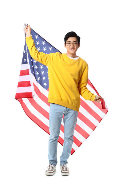 Young Asian man with USA flag on white background