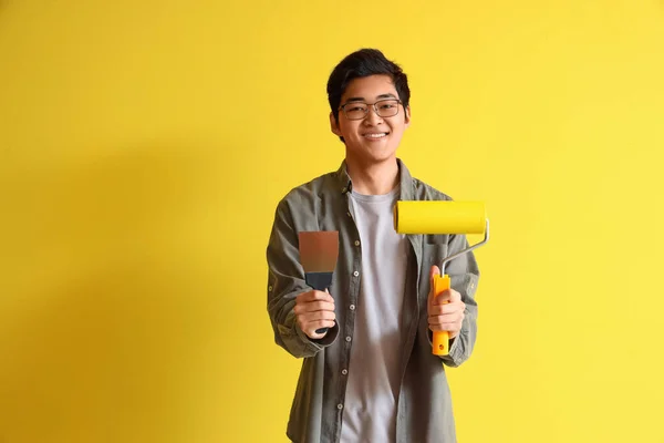 Young Asian Man Putty Knife Paint Roller Yellow Background — Stock Photo, Image