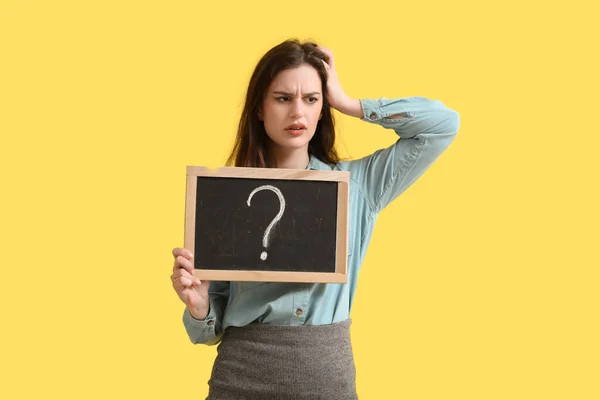 Stressed Female Teacher Holding Chalkboard Question Mark Yellow Background — Stock Photo, Image