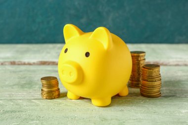 Domuz kumbaraları duvarın yanındaki yeşil ahşap masada.