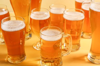Sarı arka planda bardaklar ve bir bardak soğuk bira. Ekim Festivali Kutlaması