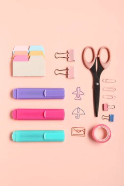 Different school stationery on pink background