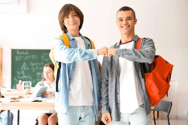 Male Students Bumping Fists Classroom — Stock Photo, Image