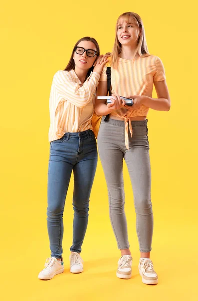 Female Students Yellow Background — Stock Photo, Image
