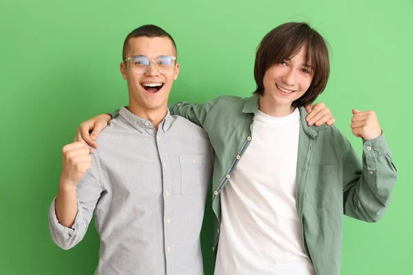 Happy Male Students Hugging Green Background — Stock Photo, Image