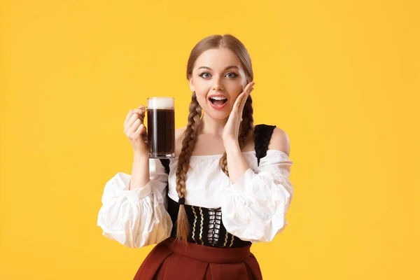stock image Surprised Octoberfest waitress with beer on yellow background