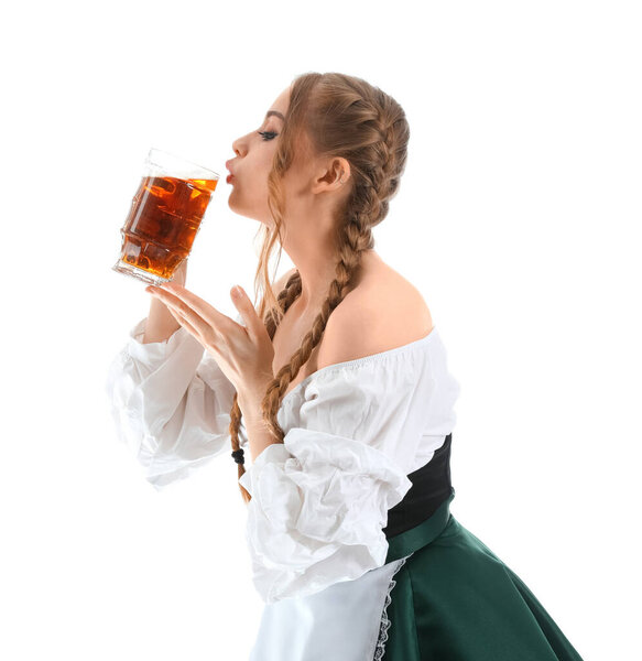 Beautiful Octoberfest waitress drinking beer on white background