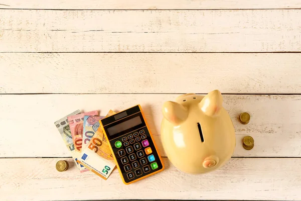 Piggy Bank Money Calculator Light Wooden Background — Stock Photo, Image