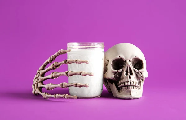 Glass Milk Skull Skeleton Hand Halloween Purple Background Closeup — Stock Photo, Image