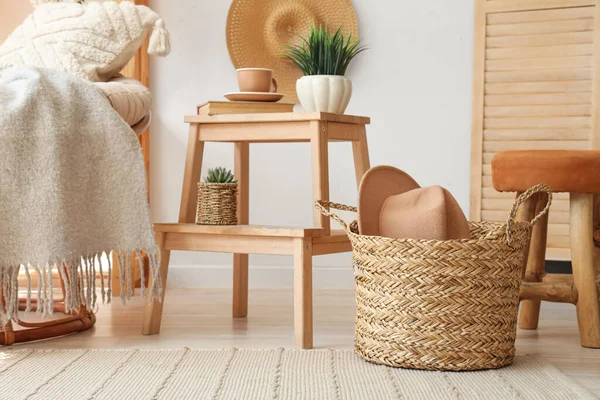 stock image Wicker basket with hat in living room interior