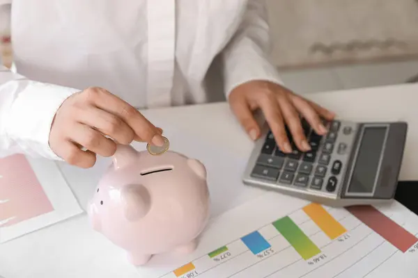 Female Student Calculating Her Finances Putting Coin Piggy Bank Student — Stock Photo, Image