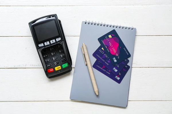 Payment Terminal Notebook Credit Cards White Wooden Background — Stock Photo, Image
