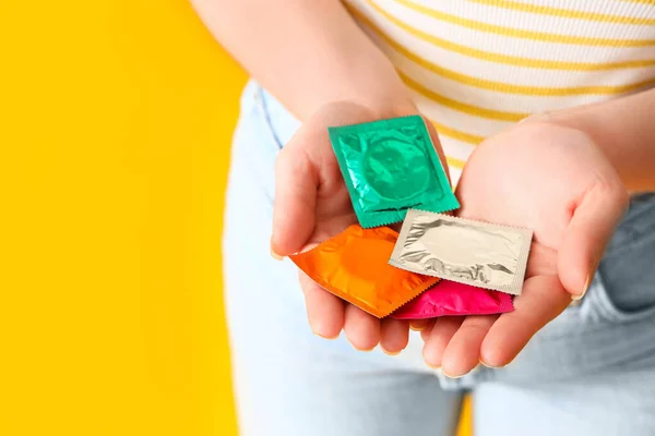 Young Woman Condoms Yellow Background Closeup — Stock Photo, Image