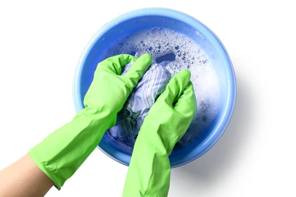 Woman in green rubber gloves washing clothes in plastic basin isolated on white background