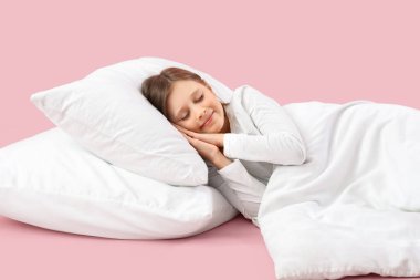 Pembe arka planda uyuyan küçük kız