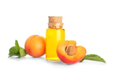 Beyaz arka planda gerekli yağ ve olgun kayısılar.