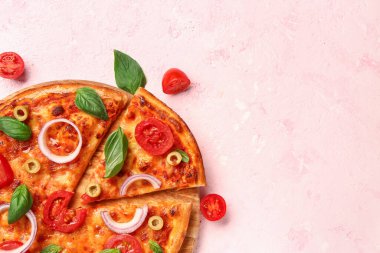 Lezzetli pizza, zeytin ve pembe arka planda fesleğen.