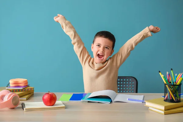 Glücklicher Kleiner Junge Macht Hausaufgaben Tisch Neben Blauer Wand — Stockfoto