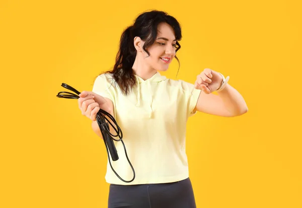 Sporty Young Woman Jumping Rope Fitness Tracker Yellow Background — Stock Photo, Image
