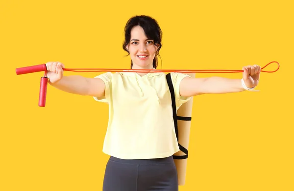Sporty Young Woman Jumping Rope Yoga Mat Yellow Background — Stock Photo, Image