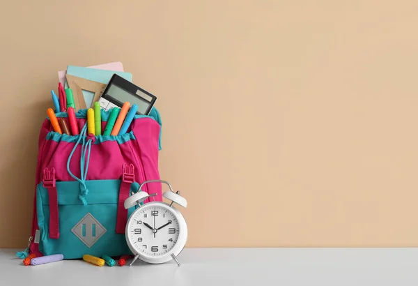 Colorful School Backpack Different Stationery Alarm Clock White Table Orange — Stock Photo, Image