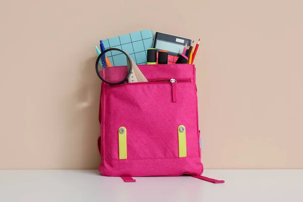Pink School Backpack Different Stationery Magnifier White Table Orange Wall — Stock Photo, Image