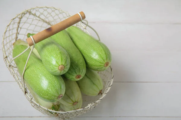 Basket Fresh Green Zucchini White Wooden Background — Stock Photo, Image