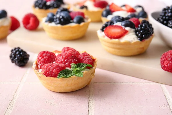 Board Tasty Tartlets Whipped Cream Berries Pink Tile Background — Stock Photo, Image