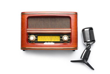 Beyaz arkaplanda mikrofon ve retro radyo alıcısı