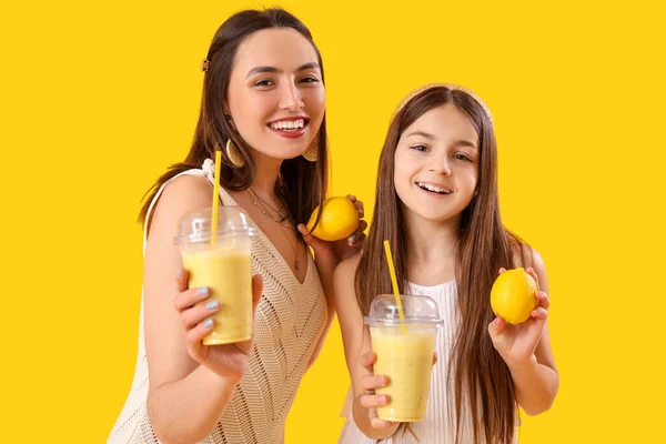 Kleines Mädchen Mit Ihrer Mutter Die Zitronen Smoothie Auf Gelbem — Stockfoto