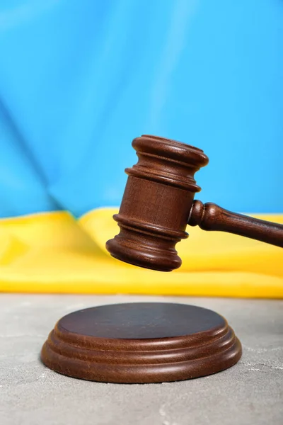 stock image Judge's gavel and flag of Ukraine on grey table