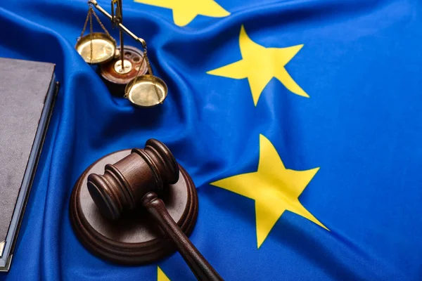 stock image Judge's gavel and scales of justice on European Union flag