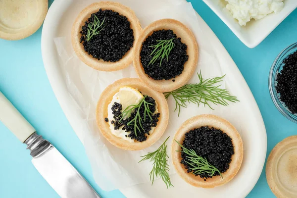 Bowl Tasty Tartlets Black Caviar Blue Background — Stock Photo, Image