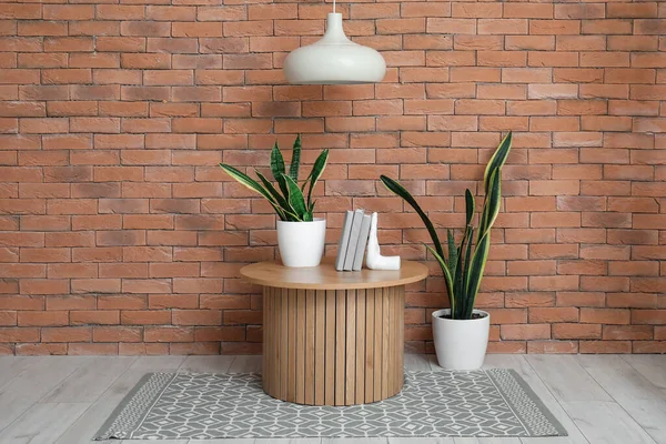 Wooden Coffee Table Houseplants Stylish Holder Books Room Brick Wall — Stock Photo, Image