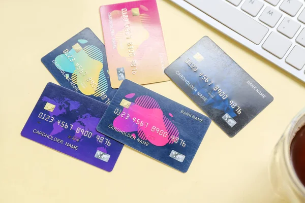 stock image Keyboard with credit cards on pale yellow background