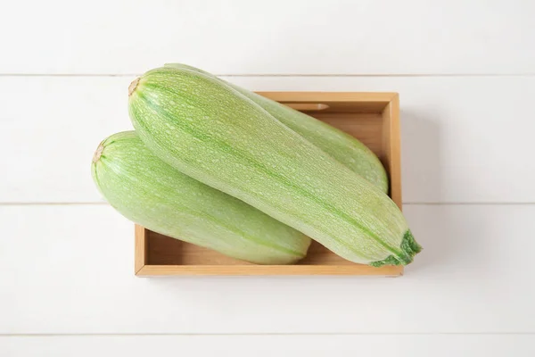 Box Fresh Green Zucchini White Wooden Background — Stock Photo, Image